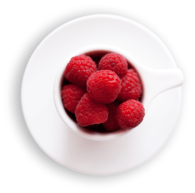 White plate filled with fresh raspberries